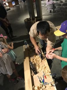 Kesh Ikuma demonstrating handplaning to kids